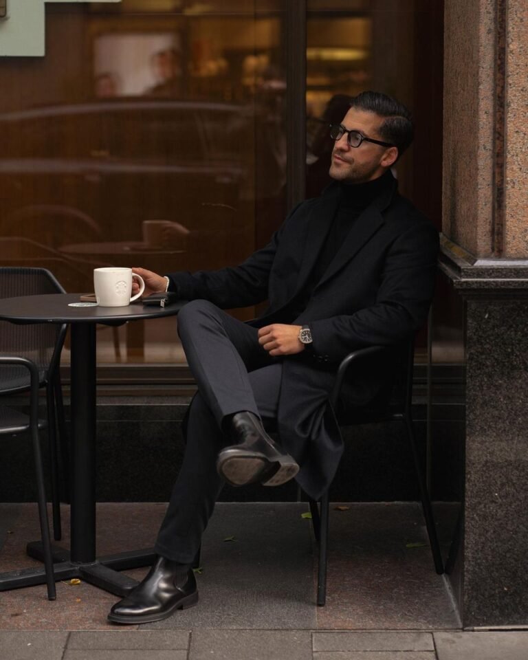 Instagram Old Money Style influencer Kosta Williams in an all-black winter outfit