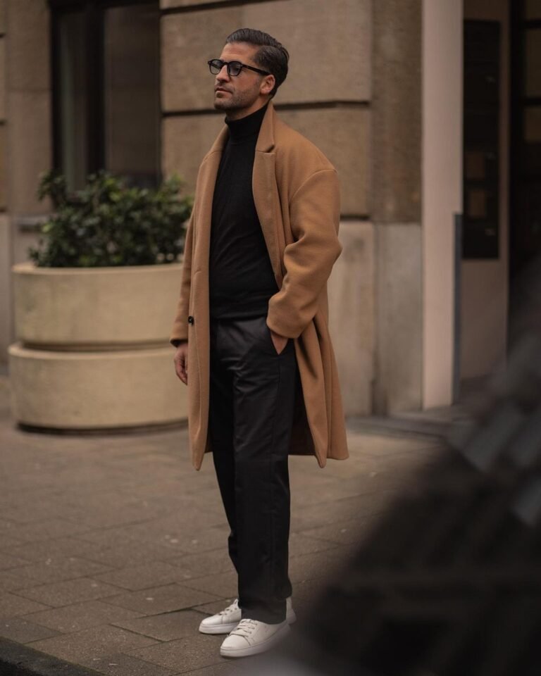 Instagram Old Money fashion influencer Kosta Williams in a beige overcoat outfit